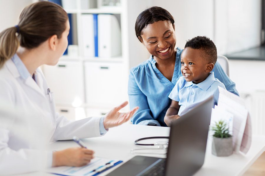 Employee Benefits - Mother and Young Child at a Doctor's Appointment